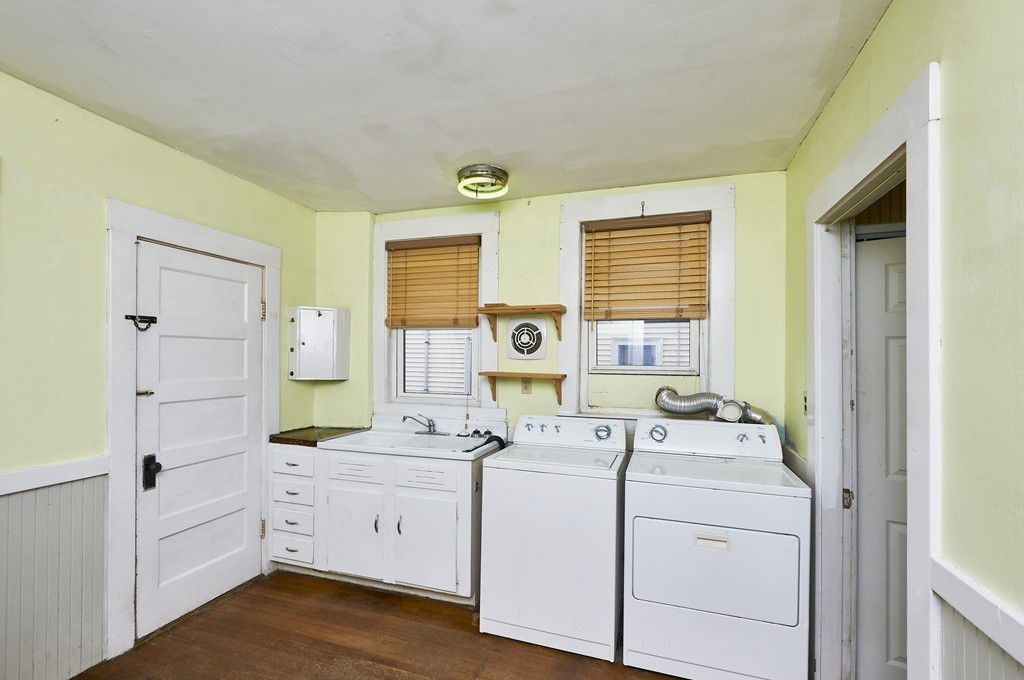 1146 Chestnut Street Newton, MA 02464 - Photo 9 of 19 a view of washer and dryer with bathroom in the background