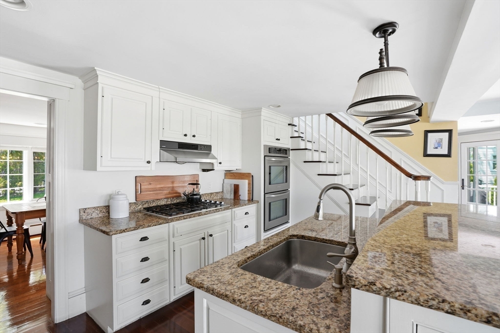 3 Talbot Road Hingham, MA 02043 - Photo 9 of 34 a kitchen with granite countertop a sink a stove and cabinets