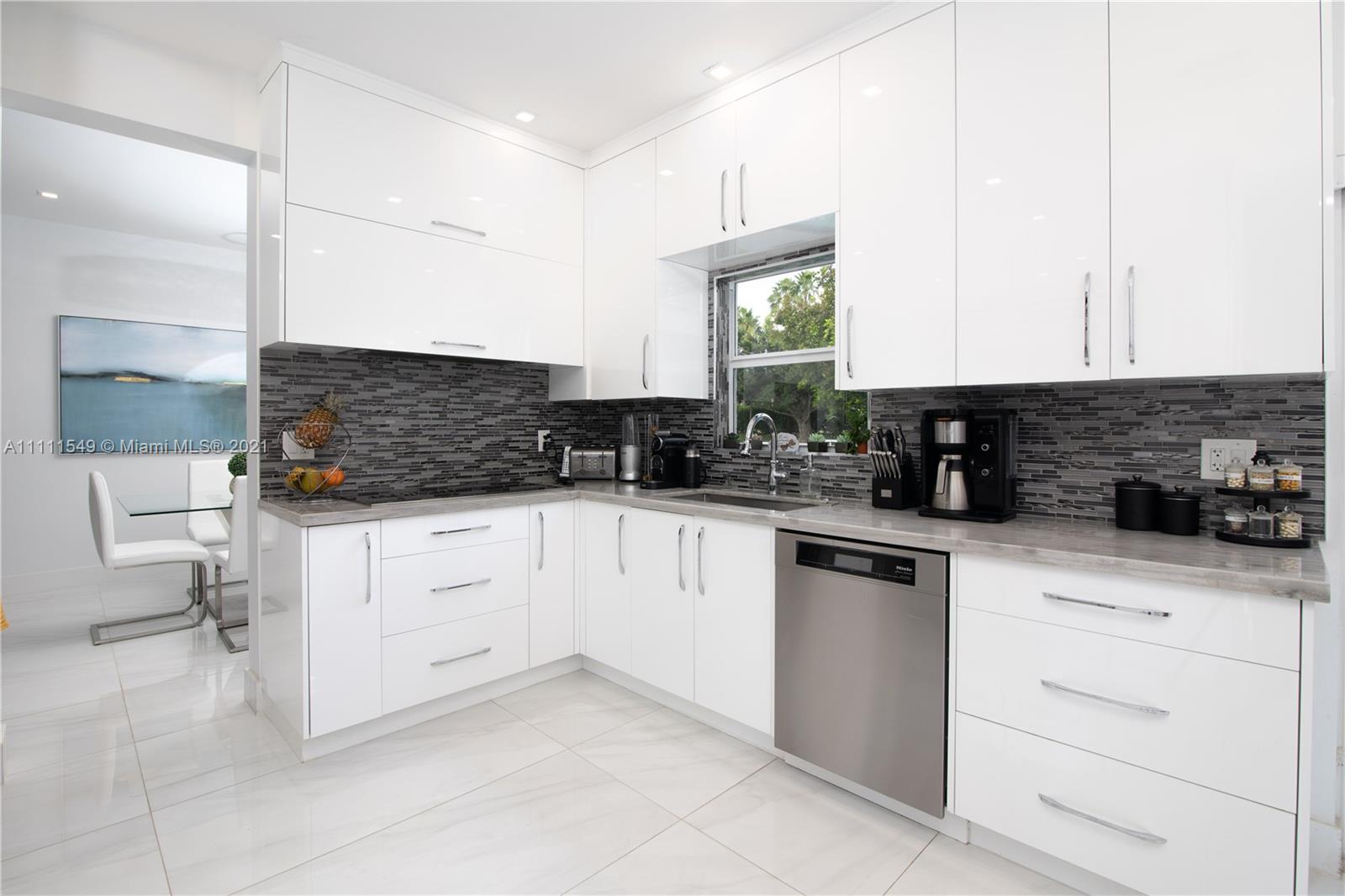 12099 Rockwell Way Boca Raton, FL 33428 - Photo 13 of 60 a kitchen with stainless steel appliances white cabinets and a sink