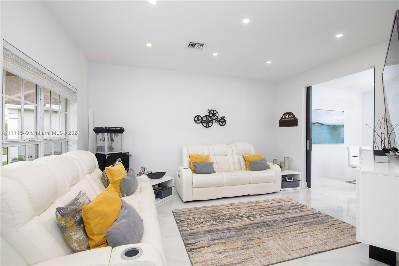 12099 Rockwell Way Boca Raton, FL 33428 - Photo 19 of 60 a bedroom with a bed a couch and a window
