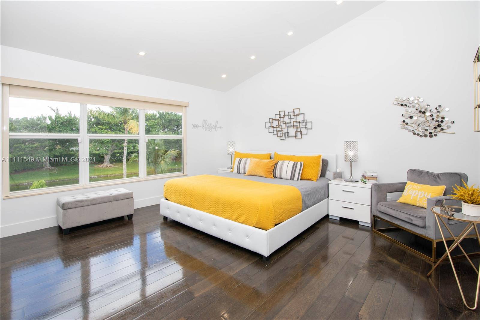 12099 Rockwell Way Boca Raton, FL 33428 - Photo 22 of 60 a bedroom with a bed and wooden floor