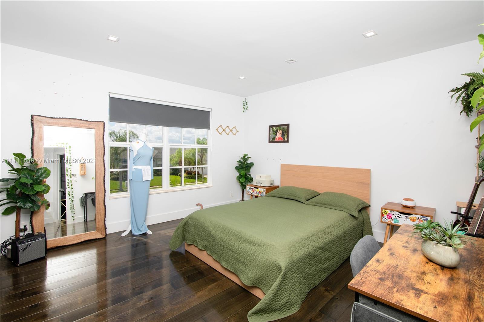 12099 Rockwell Way Boca Raton, FL 33428 - Photo 29 of 60 a bedroom with a bed and wooden floor
