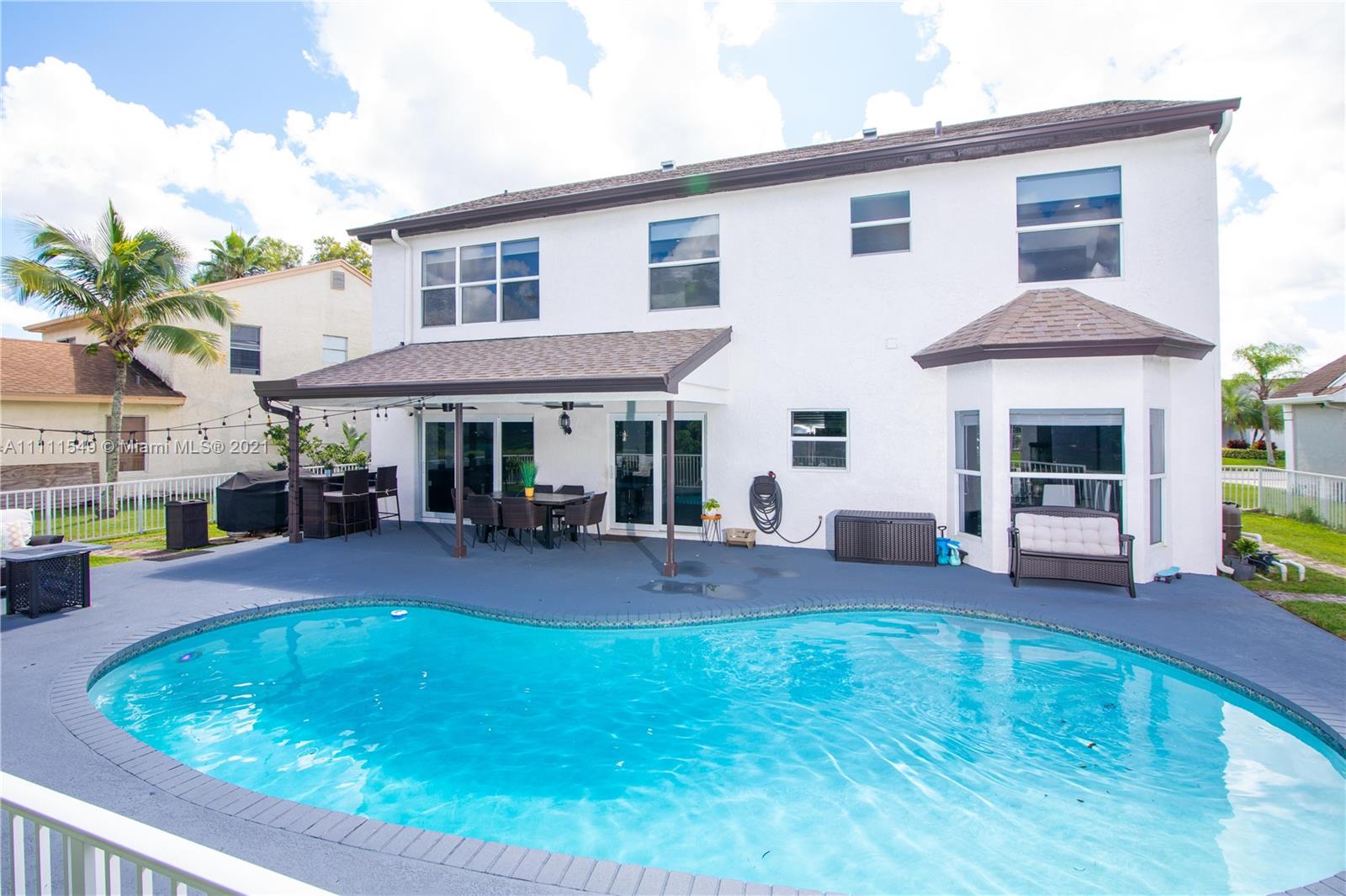 12099 Rockwell Way Boca Raton, FL 33428 - Photo 34 of 60 a view of a house with swimming pool and sitting area