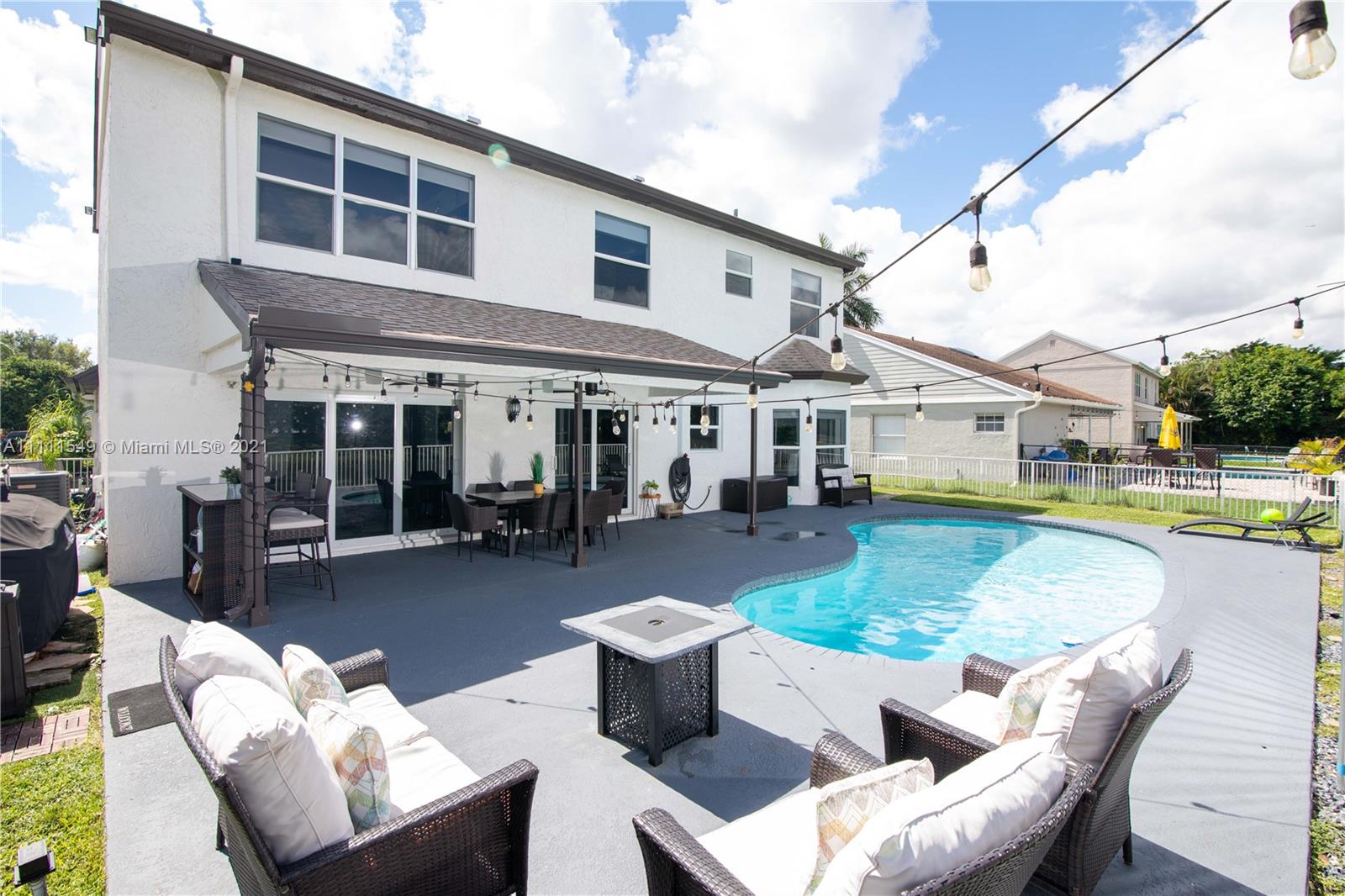 12099 Rockwell Way Boca Raton, FL 33428 - Photo 35 of 60 a view of a house with swimming pool and sitting area