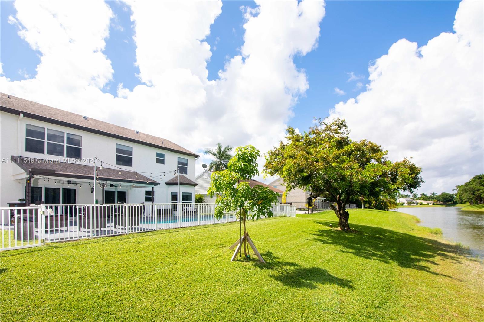 12099 Rockwell Way Boca Raton, FL 33428 - Photo 38 of 60 a swimming pool with outdoor seating and yard