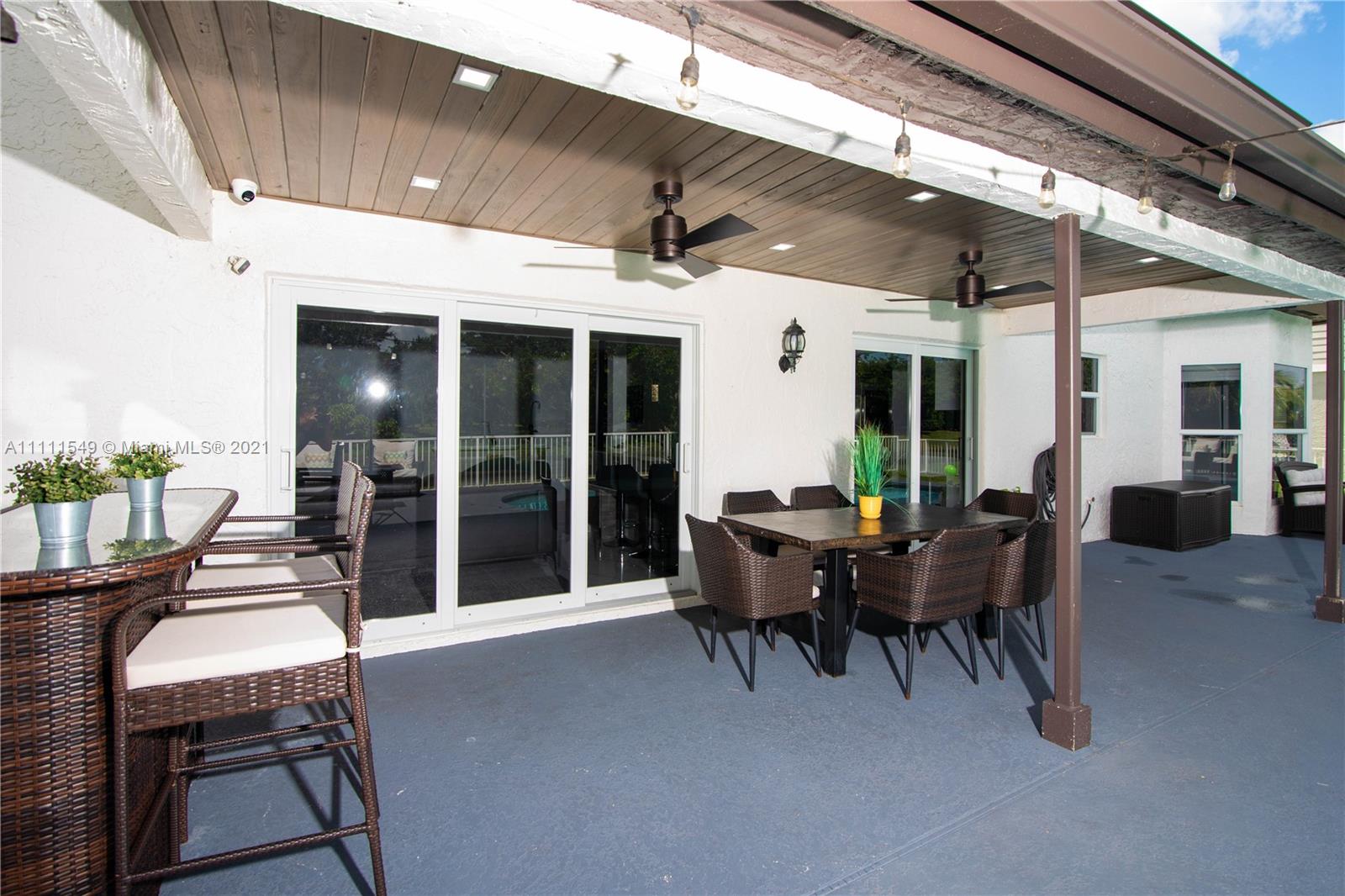 12099 Rockwell Way Boca Raton, FL 33428 - Photo 40 of 60 a view of a patio with table and chairs