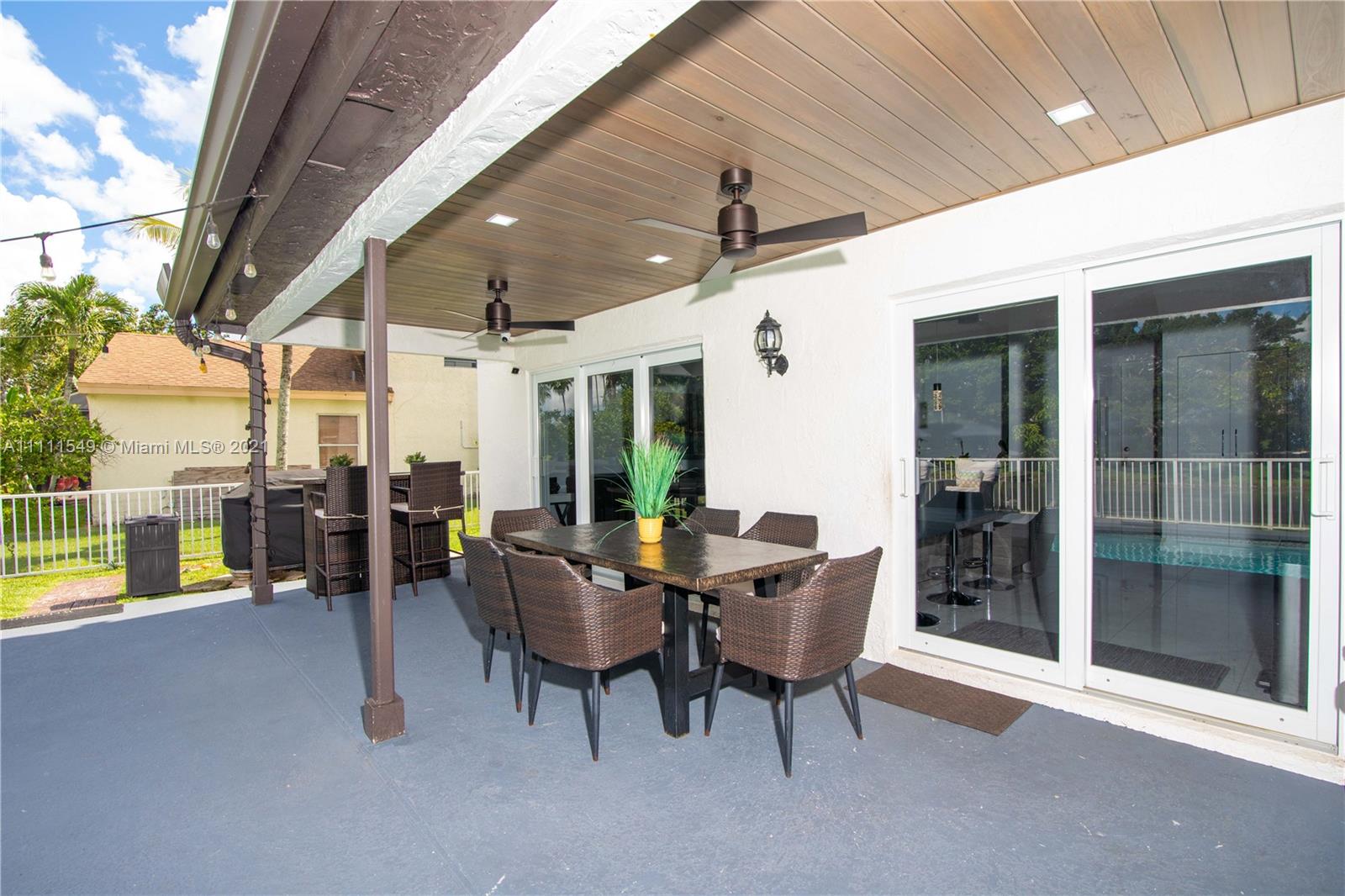 12099 Rockwell Way Boca Raton, FL 33428 - Photo 41 of 60 a view of a patio with a table and chairs