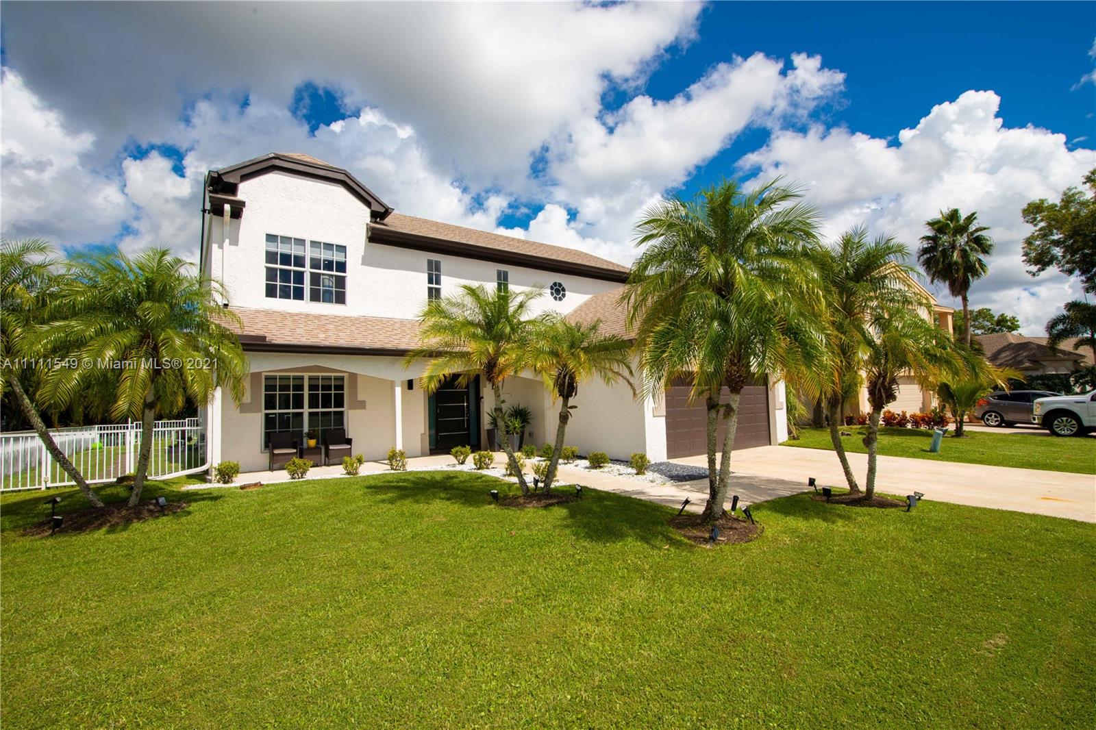 12099 Rockwell Way Boca Raton, FL 33428 - Photo 43 of 60 a view of a house with a yard and palm trees