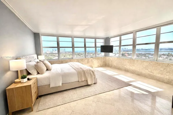 a spacious bedroom with a large bed and a large window