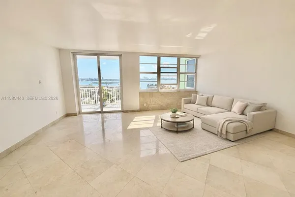 a living room with furniture and a large window