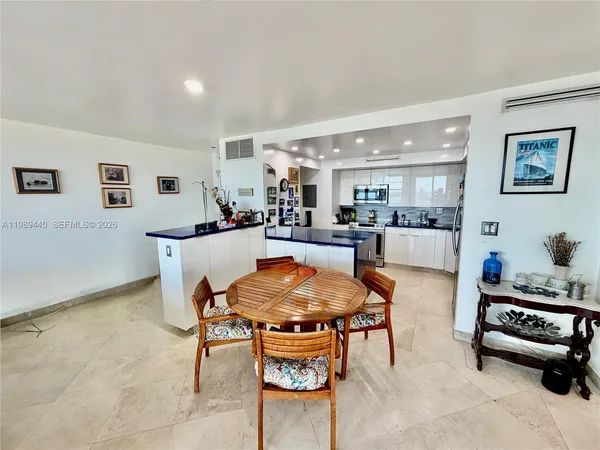 a living room with furniture and a dining table with wooden floor