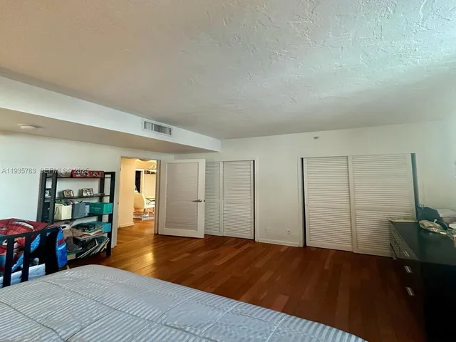 a bedroom with a bed and closet