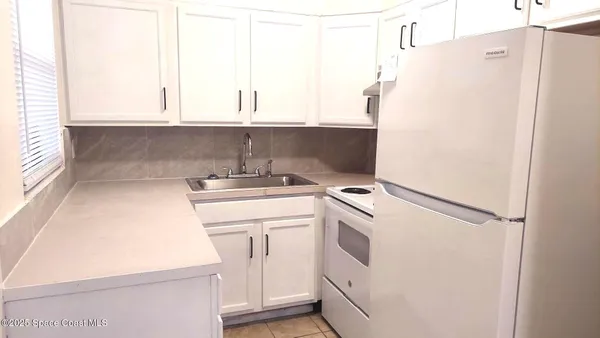 a white refrigerator freezer sitting inside of a kitchen