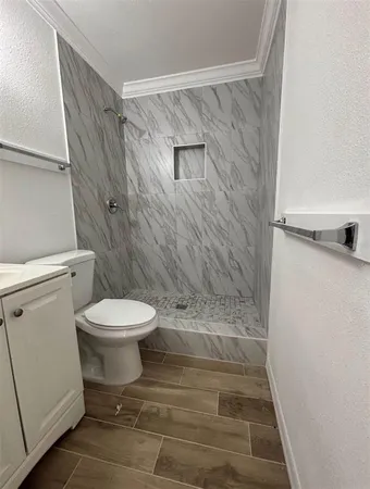 a bathroom with a toilet and a shower