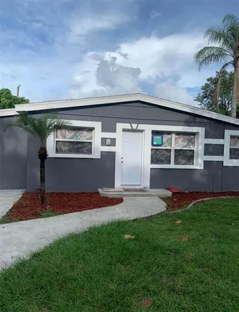 a front view of house with yard and lake view