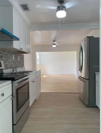 a kitchen with stainless steel appliances a refrigerator and a stove