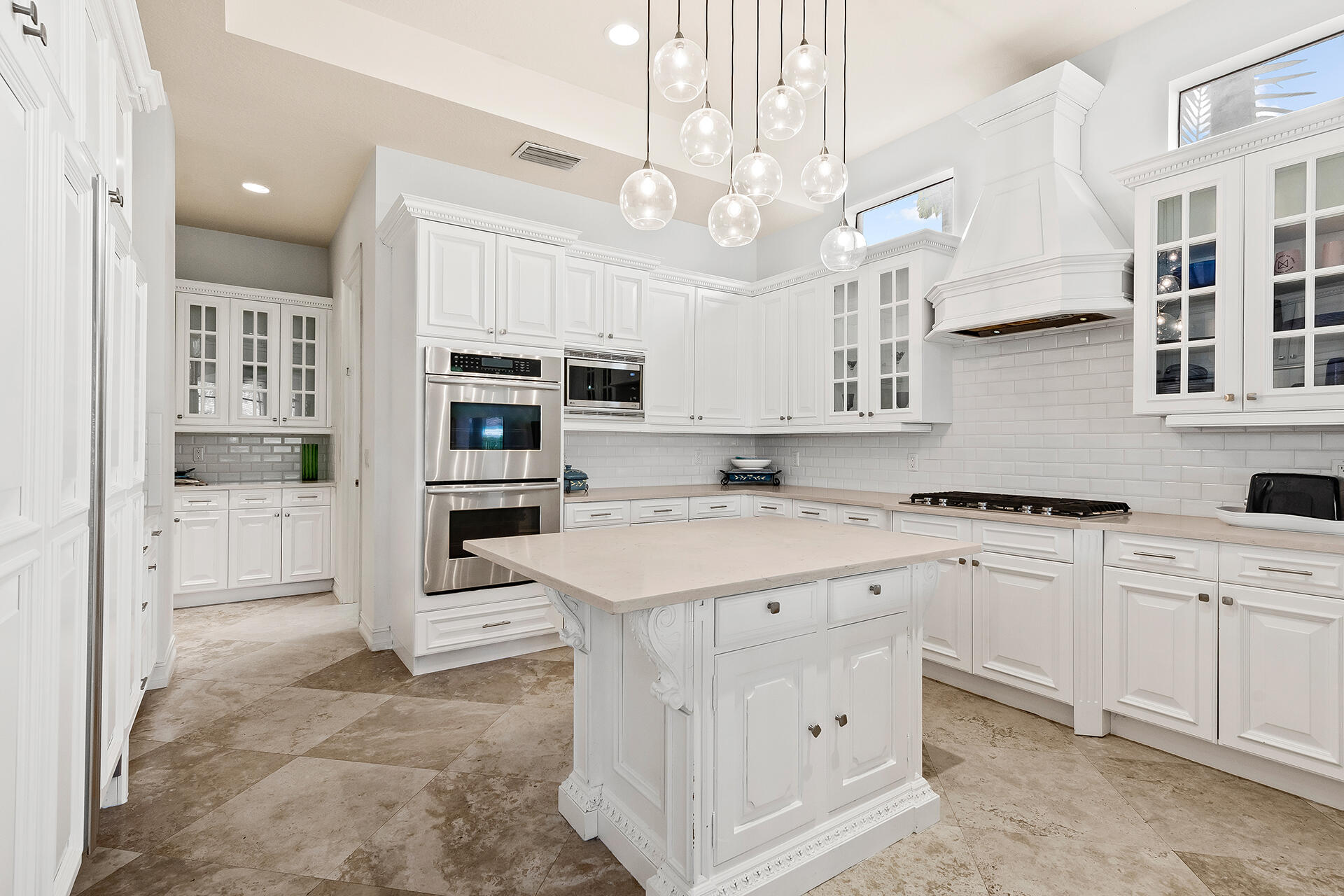 9455 Bridgebrook Drive Boca Raton, FL 33496 - Photo 13 of 63 a kitchen with a sink a counter top space stainless steel appliances and cabinets
