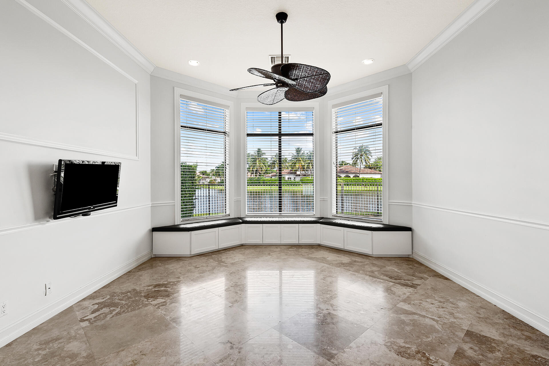 9455 Bridgebrook Drive Boca Raton, FL 33496 - Photo 19 of 63 a view of a livingroom with a flat screen tv wooden floor and windows