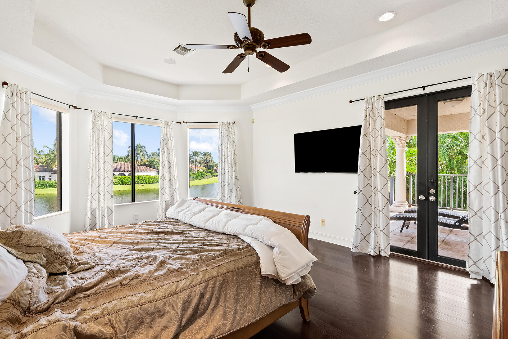 9455 Bridgebrook Drive Boca Raton, FL 33496 - Photo 23 of 63 a bedroom with a bed a flat screen tv and a large window