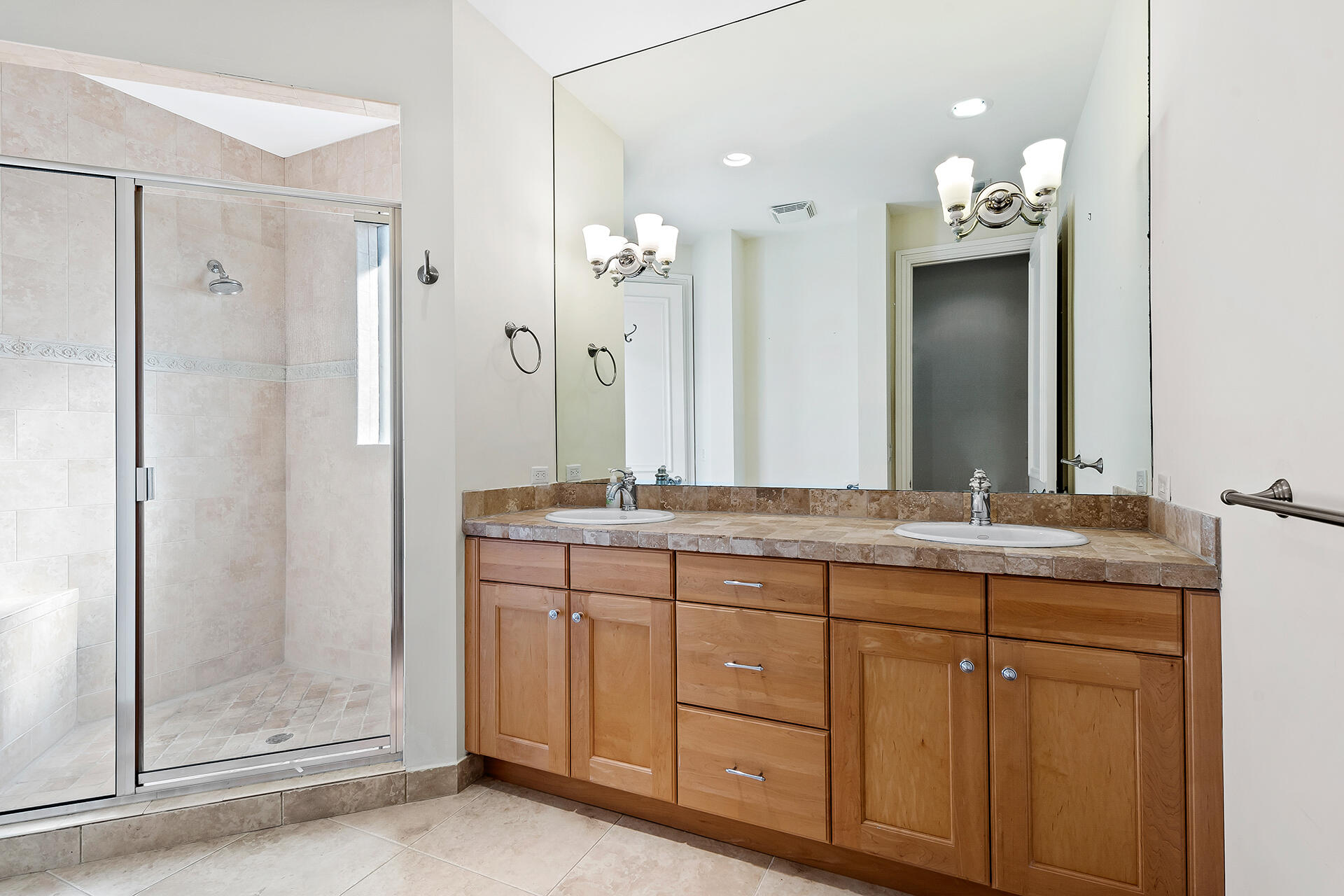 9455 Bridgebrook Drive Boca Raton, FL 33496 - Photo 36 of 63 a bathroom with a granite countertop sink a mirror and a shower