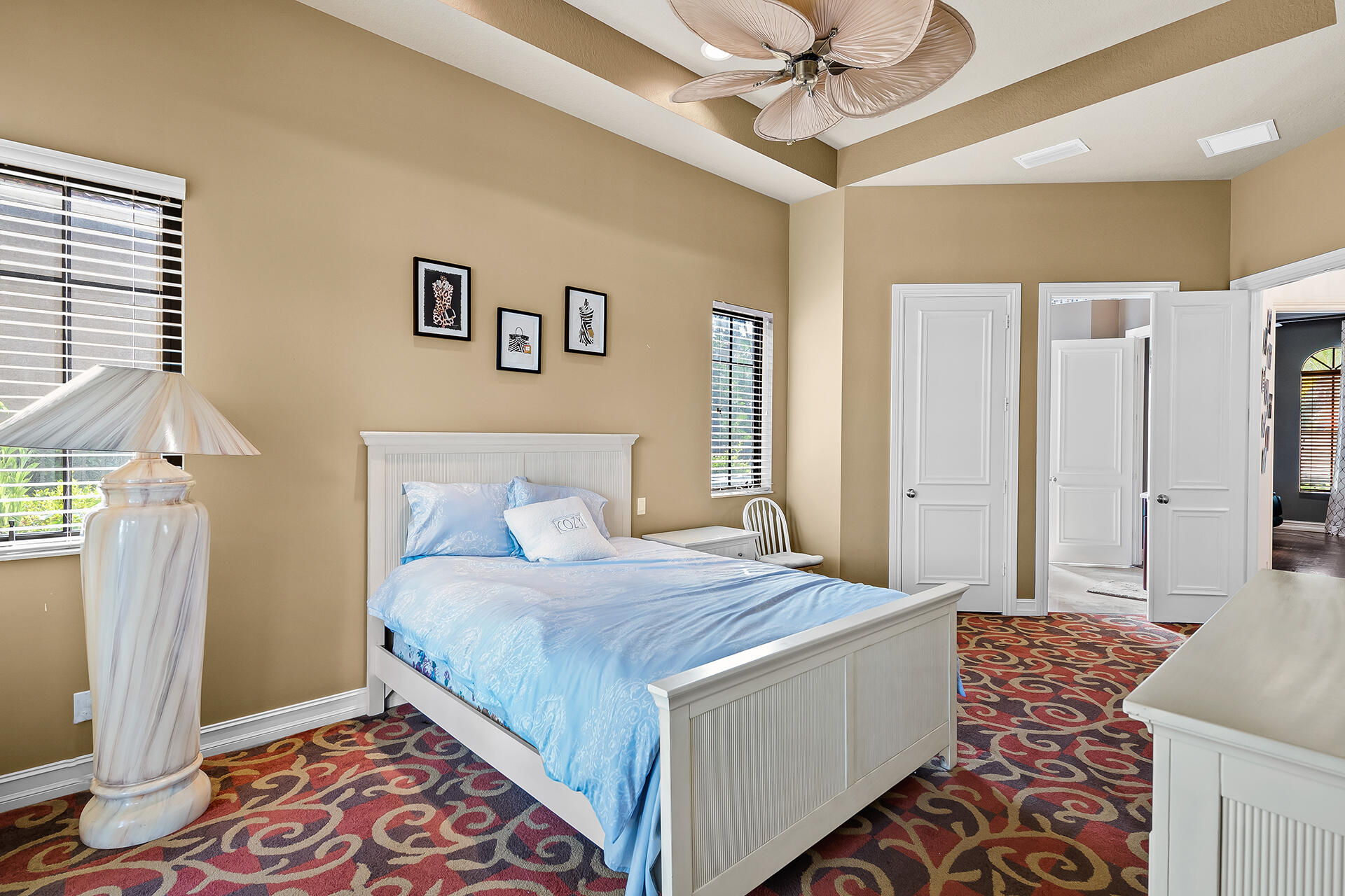 9455 Bridgebrook Drive Boca Raton, FL 33496 - Photo 41 of 63 a bedroom with a bed and a chandelier