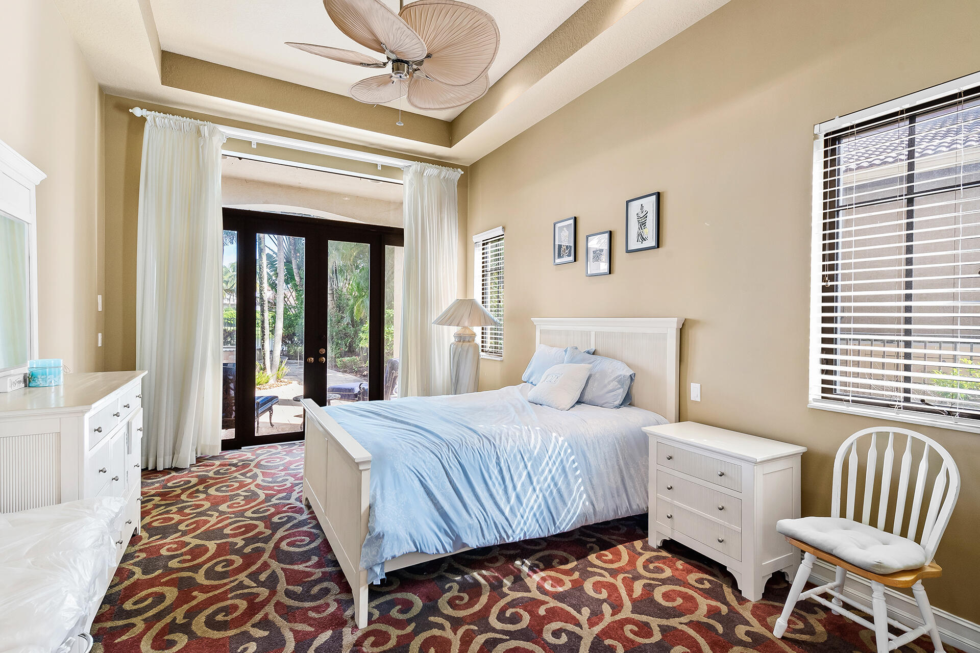 9455 Bridgebrook Drive Boca Raton, FL 33496 - Photo 42 of 63 a bedroom with a bed and a chandelier