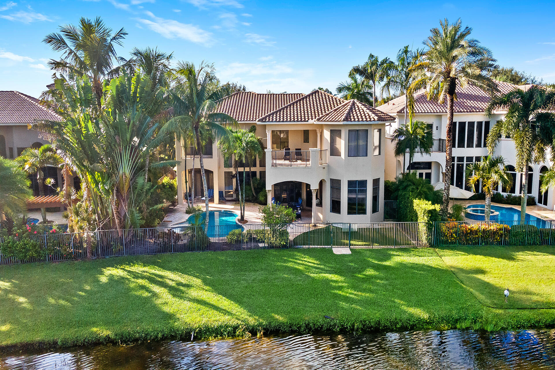 9455 Bridgebrook Drive Boca Raton, FL 33496 - Photo 54 of 63 a front view of a house with garden and swimming pool