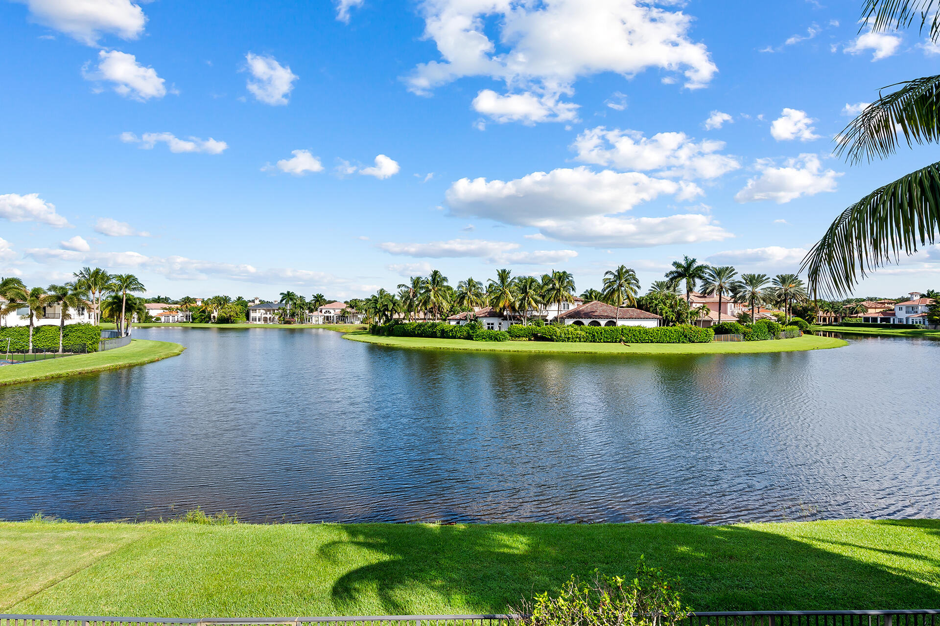 9455 Bridgebrook Drive Boca Raton, FL 33496 - Photo 57 of 63 a view of a lake with a house in the background