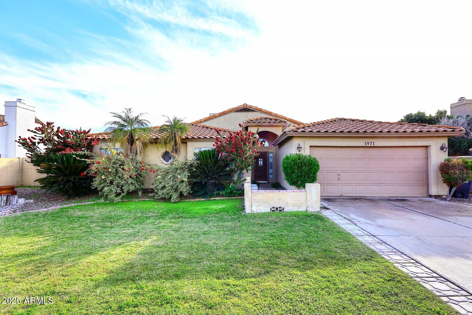 1971 East Buena Vista Drive Tempe, AZ 85284 - Photo 1 of 38 a front view of a house with a garden and plants