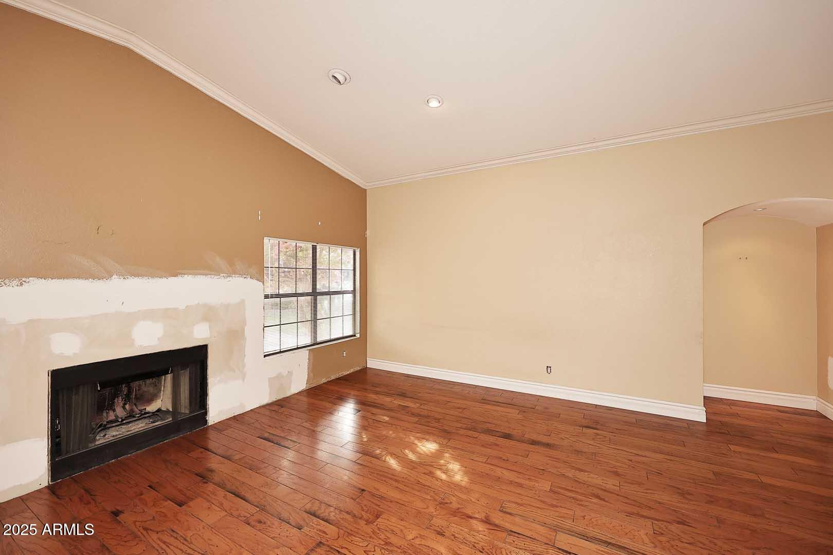 1971 East Buena Vista Drive Tempe, AZ 85284 - Photo 16 of 38 an empty room with wooden floor fireplace and windows