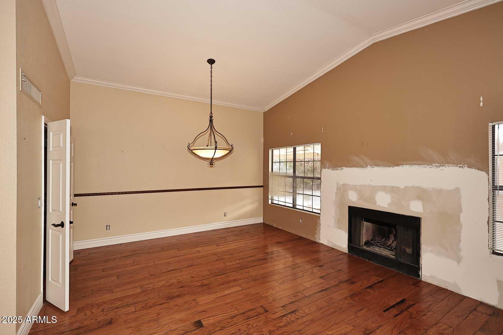 1971 East Buena Vista Drive Tempe, AZ 85284 - Photo 17 of 38 a view of empty room with wooden floor and fireplace