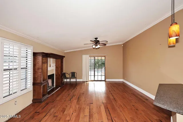 a view of a room with wooden floor and windows