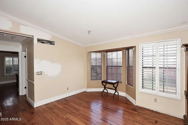 a view of a room with a wooden floor and a window