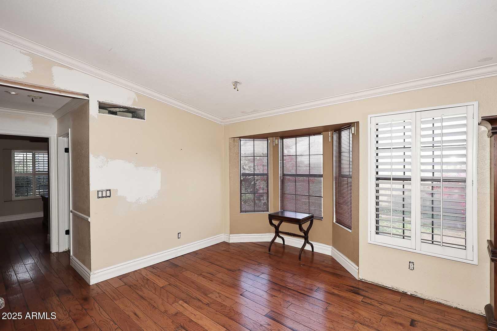 1971 East Buena Vista Drive Tempe, AZ 85284 - Photo 22 of 38 a view of an empty room with wooden floor and a window