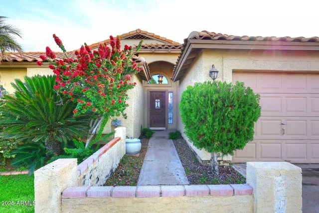 a backyard of a house with table and chairs