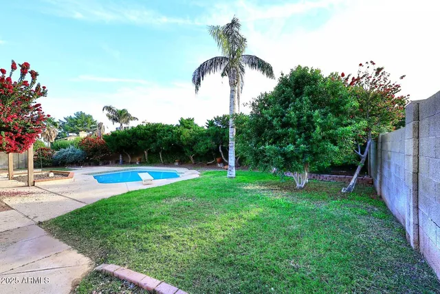 a front view of a house with a yard and a garage