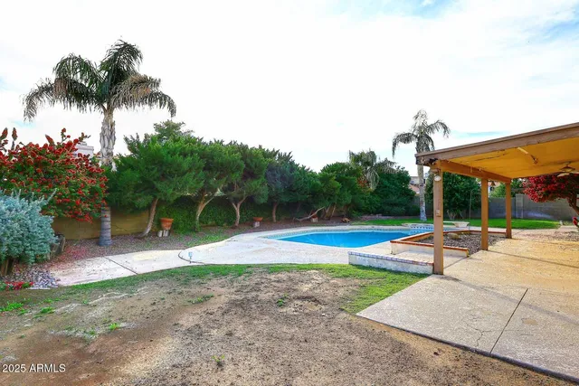 a view of a swimming pool with a patio