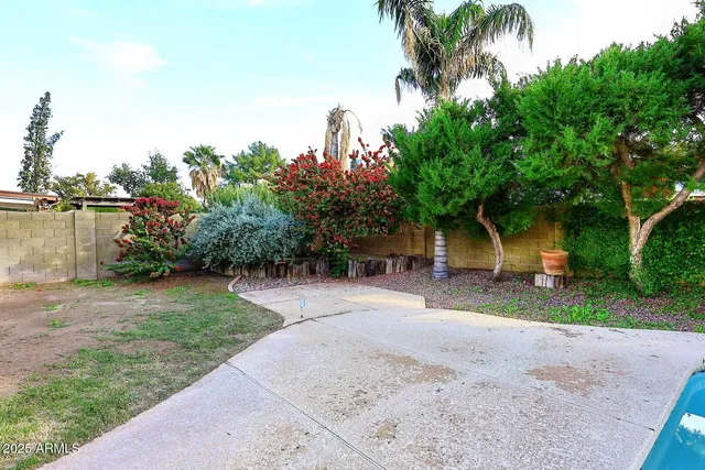 a swimming pool with barbeque oven outdoor seating and yard