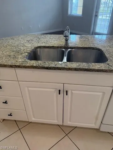 a kitchen with a sink and a refrigerator