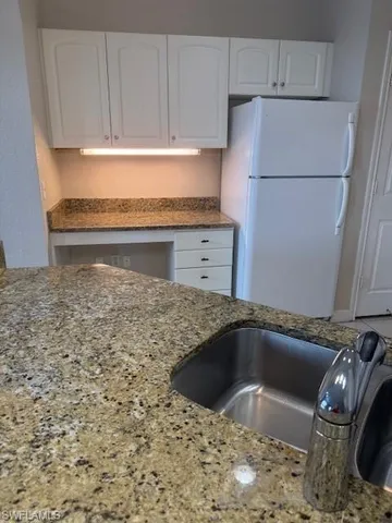 a kitchen with white cabinets