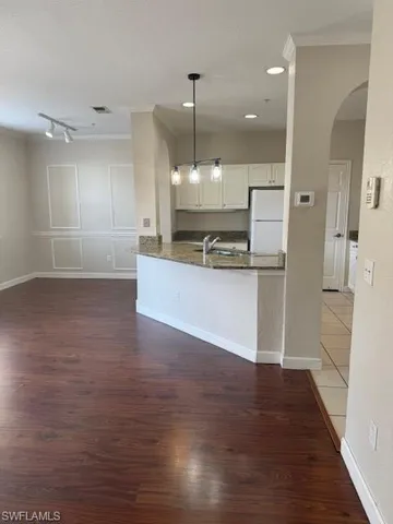 a view of a kitchen with wooden floor and a kitchen
