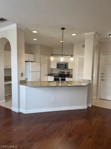 a living room with furniture and a hard wood floor