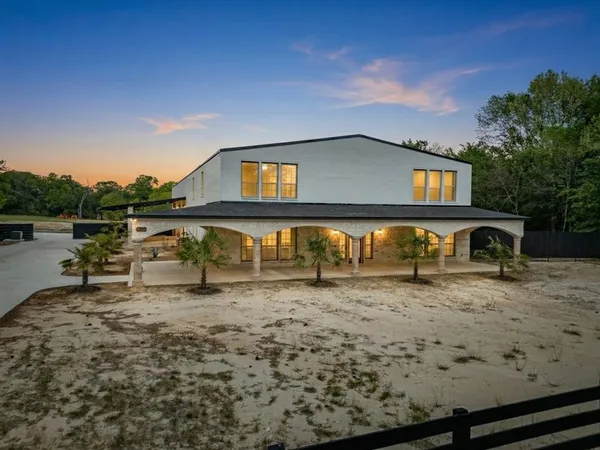 a view of a house with wooden fence