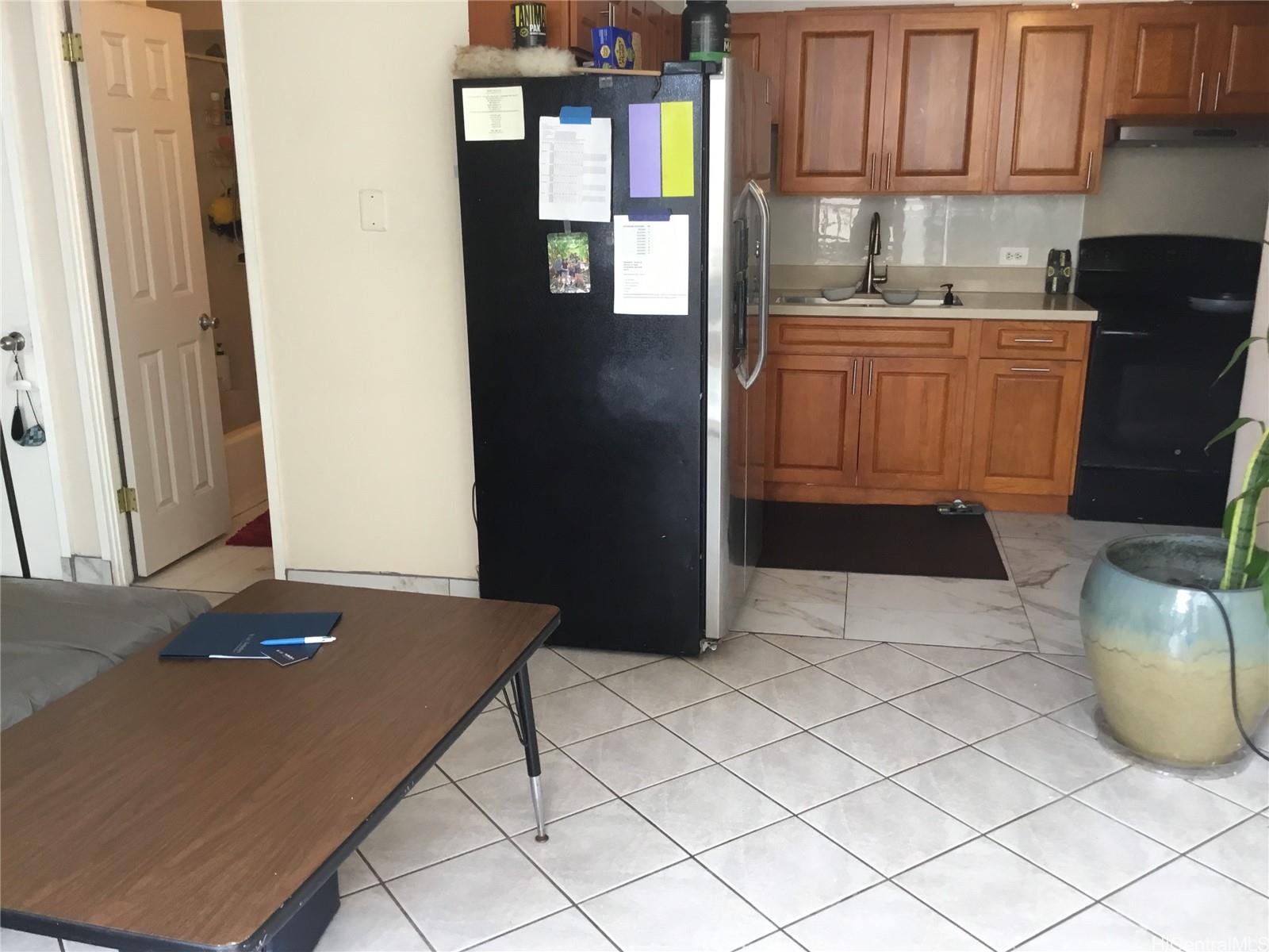 1440 Ward Avenue, Unit 301 Honolulu, HI 96822 - Photo 3 of 14 a kitchen with stainless steel appliances granite countertop a refrigerator