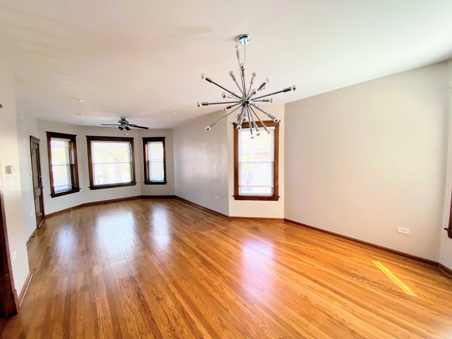 2328 North Kostner Avenue, Unit 2 Chicago, IL 60639 - Photo 7 of 10 a view of an empty room with wooden floor and a window