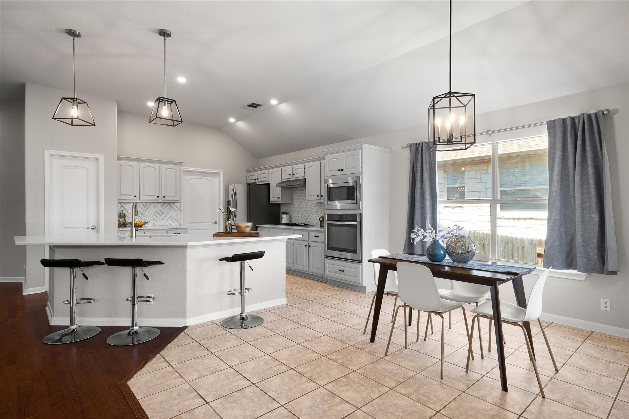 100 Stratton Court Austin, TX 78737 - Photo 11 of 38 The kitchen island breakfast bar is a great place for your morning cereal.