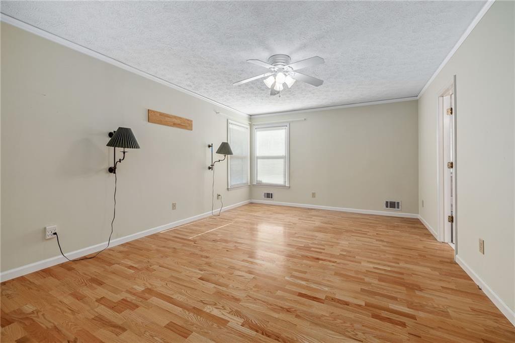3374 Floral Court Suwanee, GA 30024 - Photo 18 of 54 a view of empty room with wooden floor