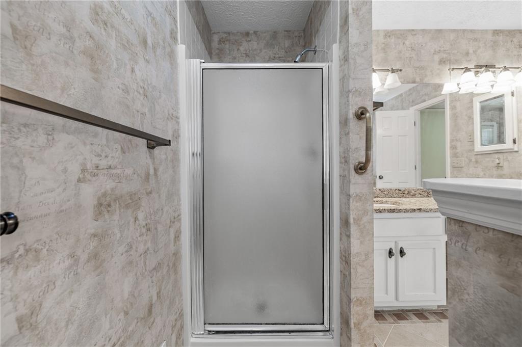 3374 Floral Court Suwanee, GA 30024 - Photo 21 of 54 a bathroom with a shower and a sink