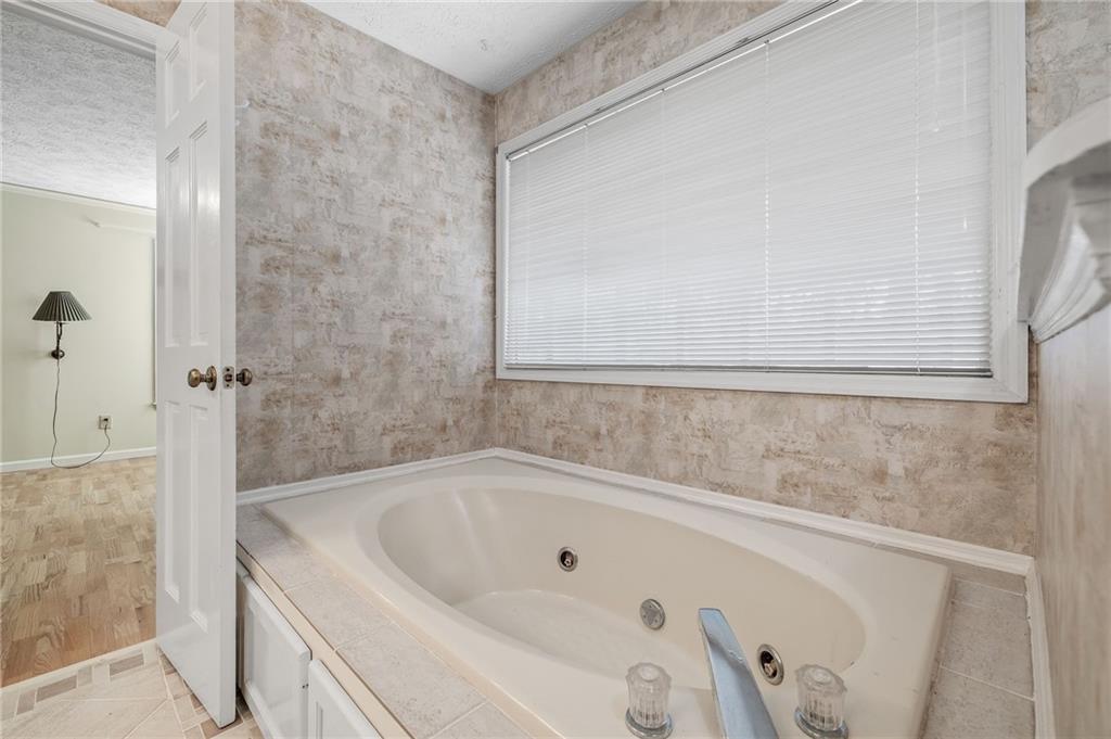 3374 Floral Court Suwanee, GA 30024 - Photo 22 of 54 a bathroom with a bathtub