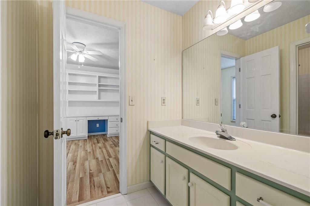 3374 Floral Court Suwanee, GA 30024 - Photo 27 of 54 a bathroom with a sink a light fixture and a mirror